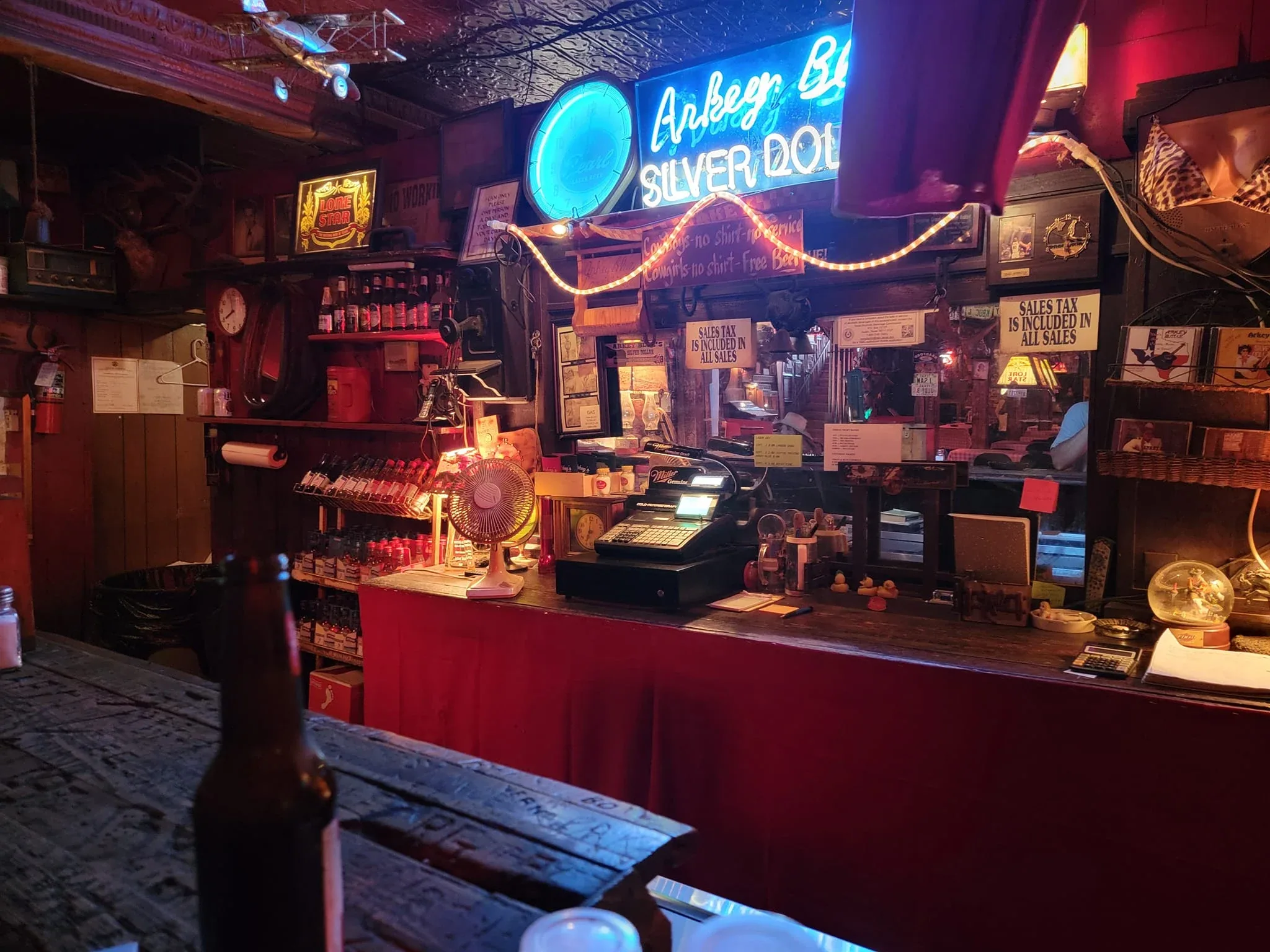 Neon-lit facade of the Silver Dollar Saloon on Main Street in Bandera