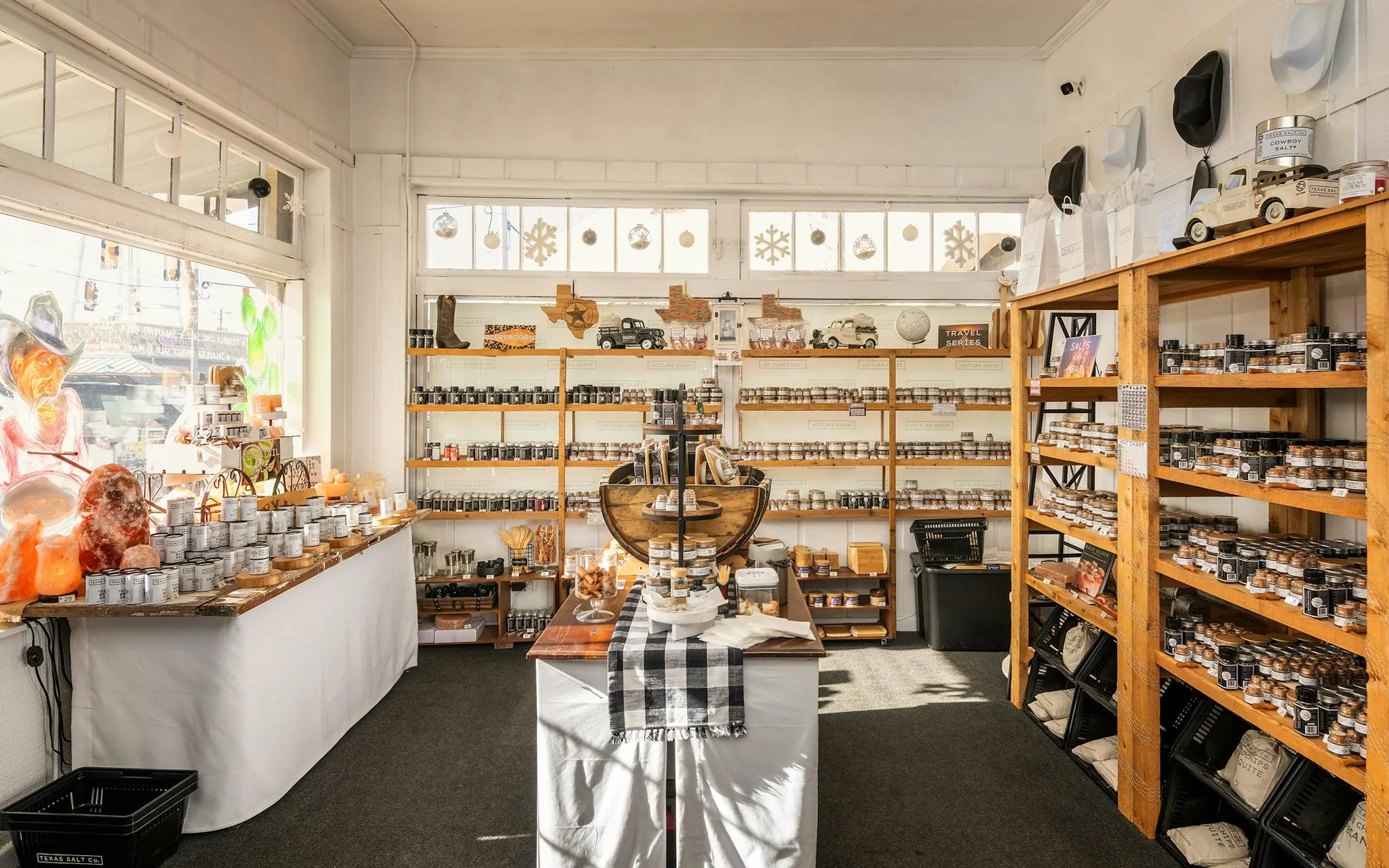 Tins and bags of Texas Salt Co. seasoning including Cowboy Salt on a shop display
