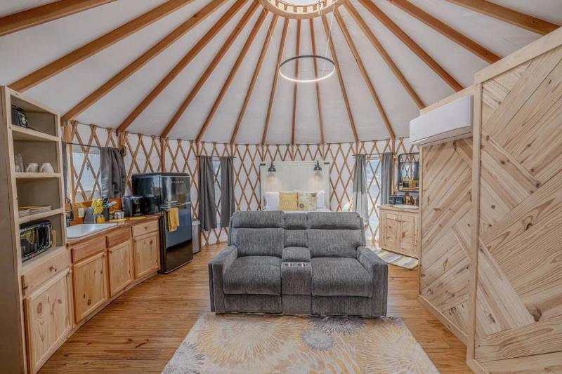 Canary Yurt — bright central living area beneath the circular roof beams.