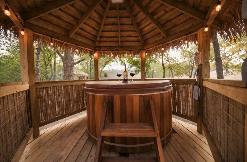 Hoot Owl Yurt — round cedar hot tub inside the private lighted gazebo.