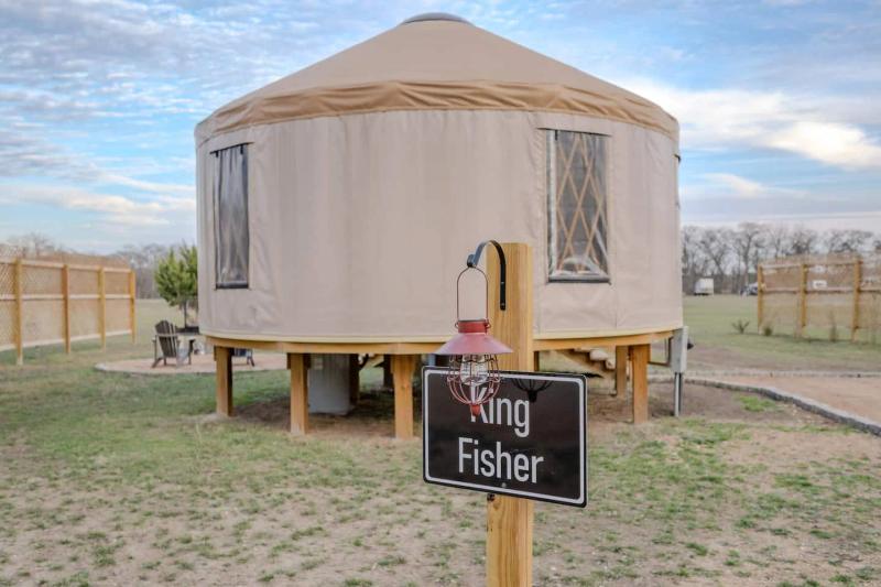 King Fisher Yurt — entrance sign in front of the elevated canvas yurt.