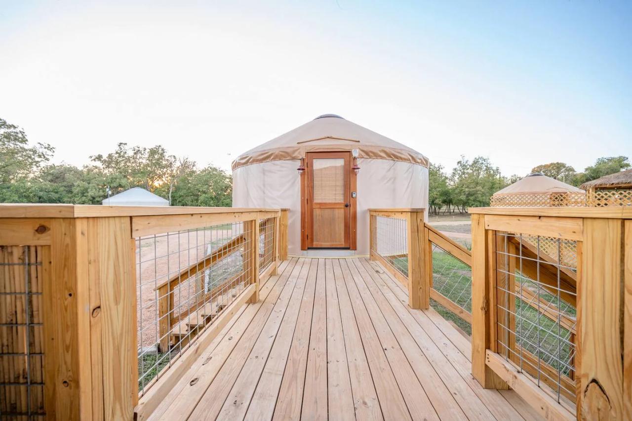 King Fisher Yurt — long wooden entry walkway leading to the yurt at sunset.