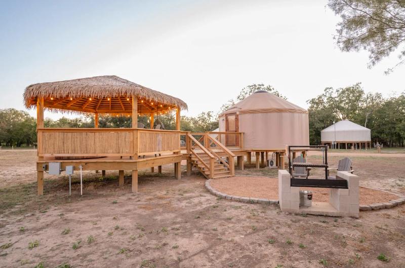 Peacock Yurt — full outdoor retreat with gazebo, yurt, fire pit, and seating.