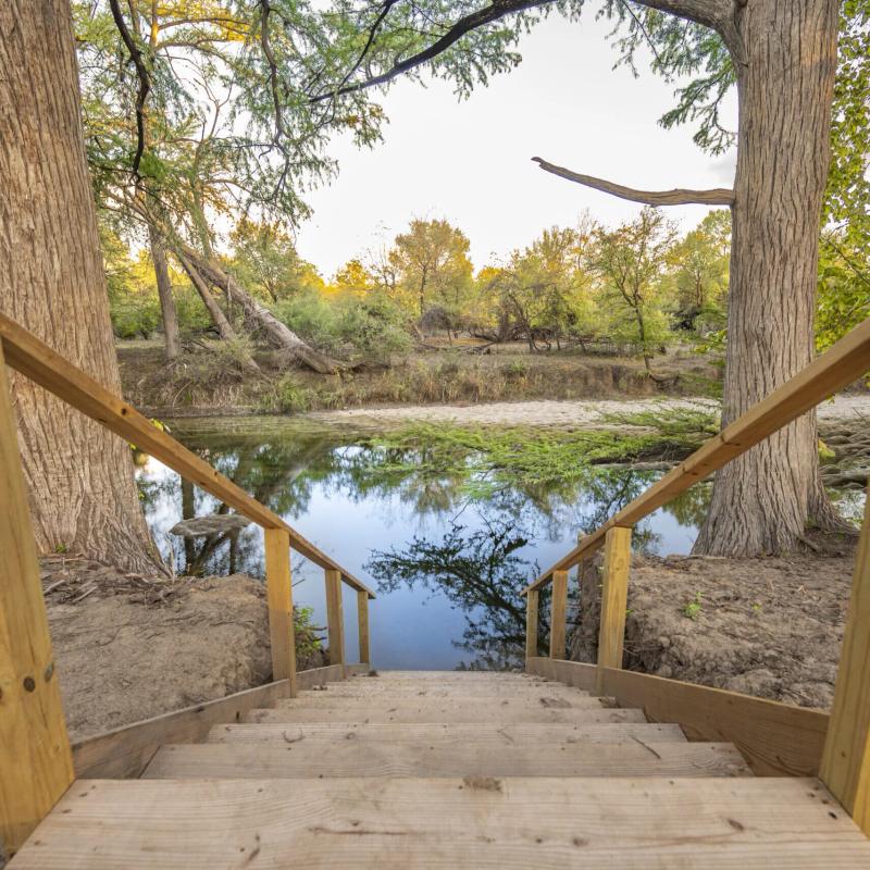 River Yurt Village RV Park — one of the four sets of wooden steps leading down through the cypress to the water.